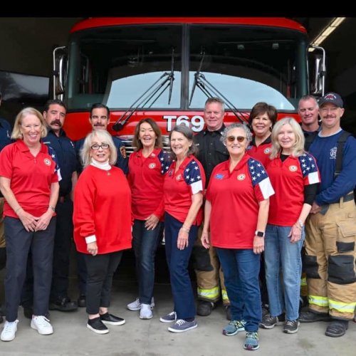 12-6-24 - ALA Unit 283 Pacific Palisades members L-R: Pat Borgeson, Sally Agrusa, Fran Aponte, Gina Jakel, Arlene Vaillancourt, Ruth Kahn, Ruta Finestone and Sue Pascoe with LA City Fire Station 69 Captain Jeff Brown and some of the firefighters from that station. Photo Credit: Ruth Kahn.